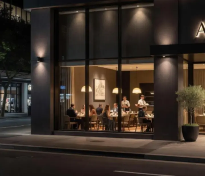Exterior of Theflopand Flame restaurant at night with warm lighting